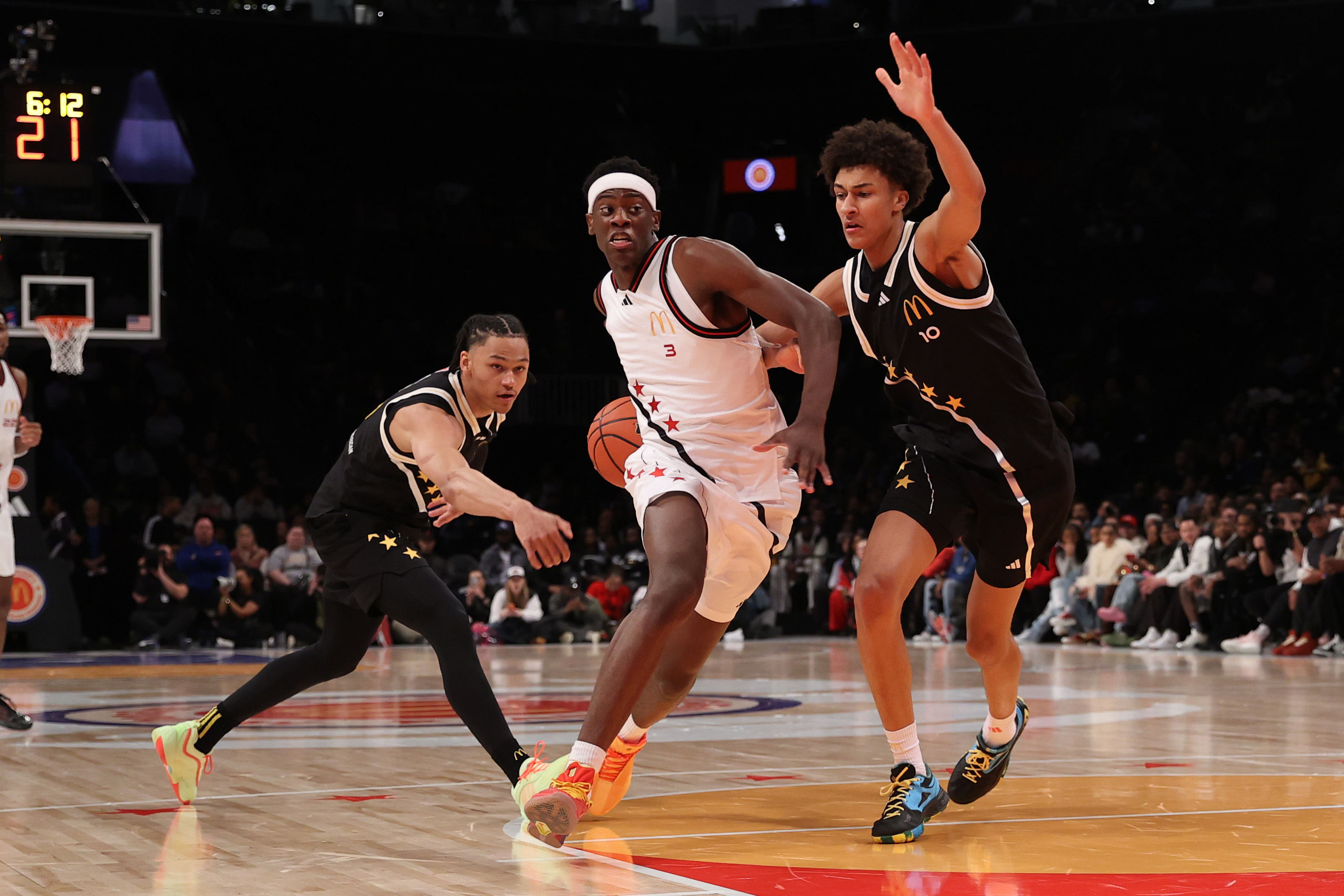 McDonald's All American West forward AJ Dybantsa (#3) drives to the basket against McDonald's All American East guard Zai Harwell (#0) and McDonald's All American East forward Nate Ament (#10) during the first half of their game at Barclays Center. Photo: Imagn